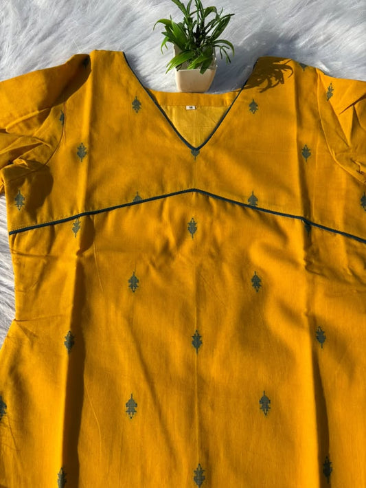 LSV 522 [ Mustard gold meets deep  green whispers. Delicate leaf motifs scattered across pure elegance,framed by a sharp v - neck and subtle empire piping